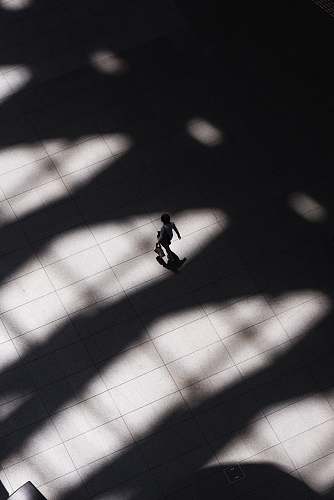tokyo international forum woman walking on white tiled flooring chiyoda-ku
